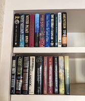 Top shelf of hardcover books showing Patterson, Higgins Clark and others