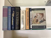 Shelf view of eight books showing spines and titles