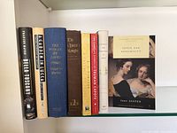 Shelf view showing all eight books standing in order, titles visible