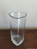Full view of clear glass vase showing rectangular base and side pattern