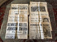 Group shot of all newspapers arranged in two columns on table