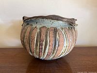 Side view showing ribbed body and glaze