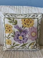 Front view of pillow showing needlepoint floral design