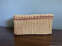 Front view of rectangular woven basket showing weave and red stripe
