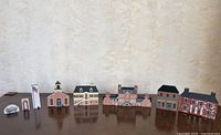 All seven Cat's Meow Jackson Village pieces lined up on table