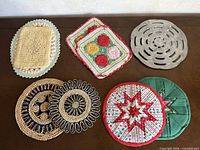 All eight trivets laid out showing variety