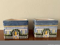 front view of both planters showing cottage doors and picket fence