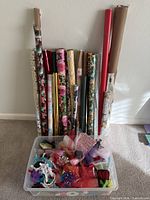Lot overview showing wrapping paper rolls and tote with accessories