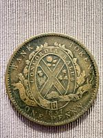 Obverse of 1837 Quebec 1 penny token showing shield, wreath, inscriptions