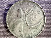 Close-up of 1950 Canadian 25-cent coin reverse