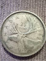 Obverse side showing caribou and 25 CENTS 1953 legend