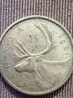 Reverse side showing caribou, date and denomination