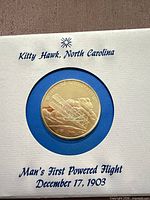 Coin in display card showing full presentation text