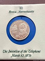 Obverse of coin in card display showing bust of Alexander Graham Bell and inscription