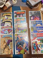 All 12 comics laid out in three columns showing each four-issue set