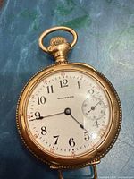 Front view of pocket watch showing dial and hands