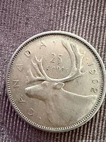 Reverse showing Caribou and 25 CENTS 1962