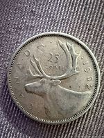 Obverse side of 1962 Canadian quarter showing caribou and date