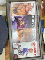 All four Chucky comic books bagged and boarded in a display frame