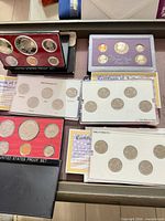 Overview of all six proof sets in tray