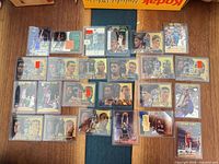 Full layout of all 24 basketball cards in sleeves