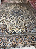 Full view of rectangular Kashan rug showing complete medallion and border pattern