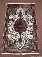 Full overhead view of the Tabriz rug showing overall design, colours and fringe