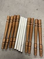 All twelve legs laid out, showing wood and metal sets