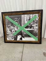 Framed Audrey Hepburn print front view with masking tape across glass