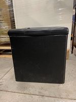 Front and side view of black leather cube ottoman