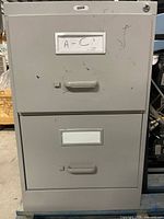 Front view of grey 2-drawer Staples filing cabinet