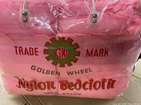 Front of packaged pink bedcloth showing Golden Wheel trademark and product name