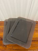 Three stacked translucent gray IKEA plastic platters