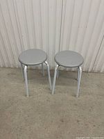 Front view of both grey stools