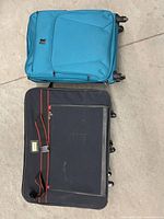 Blue IT suitcase closed, black suitcase opened top view