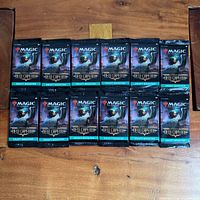 all 12 sealed Streets of New Capenna draft booster packs laid out face up