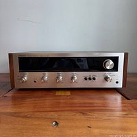 Front view of Pioneer SX-424 receiver showing entire unit and wood cabinet