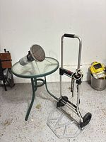 Overall view of heater on bistro table beside folded hand truck