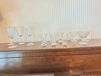All 13 etched crystal stemware pieces lined up on surface