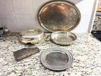 All five silver-plated serving pieces displayed together