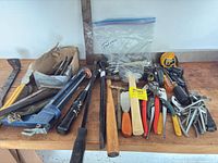 Full spread of assorted hand tools on bench