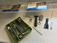 Flatware in tray, shelf risers, kitchen tools grouped