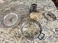 Group shot of all seven silver-plated pieces on countertop
