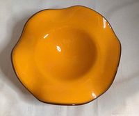 Top view showing ruffled rim and solid amber colour