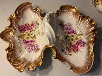 Top view of divided porcelain dish showing floral decoration and gold trim