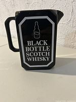 Front view showing label graphics and handle