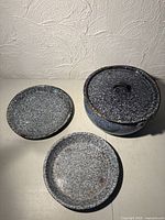 Covered pot, lid, two matching plates displayed