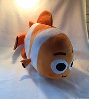 Front three-quarter view of large Nemo plush