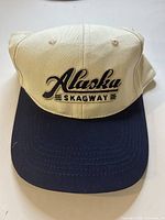 Front view of beige crown and navy brim cap showing Alaska Skagway embroidery
