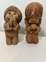 Front view of both Fannykins praying boy and girl figurines standing side-by-side